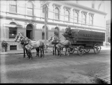 Image: New Zealand Express Co Ltd furniture movers' covered wagon, driver with four Clydesdale horses, in front of Queensland Insurance Co Ltd and Buchanan & Coy Ltd buildings, probably Christchurch region