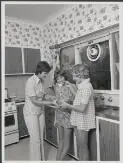 Image: Jennifer Turrall, 13 and Sally Lockyer, 14 members of the Australian swimming team in the Commonwealth Games in New Zealand in January 1974, in the kitchen with Mrs Turrall [picture].
