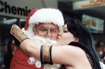 Image: Christmas parade, Stokes Valley, 1998; Santa gets a kiss.