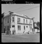 Exterior view of the Royal Tiger Hotel, Abel Smith Street, Te Aro, Wellington, including two unidentified men standing outside and talking