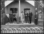 Maori meeting house, Ebbett House, Ebbett Park, Hastings with men and women standing in front