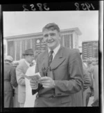 Neville McEwan holding Wellington Trotting Club booklet at Hutt Park Raceway, Gracefield, Lower Hutt, Wellington Region