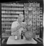 Pouring a drink in a bottling factory, Masterton, Southern Wairarapa