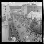 Dixon Street, Wellington, looking towards Mount Victoria, during Festival of Wellington parade, showing parade floats, spectators, and buildings including Kings Theatre