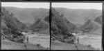 Man, sitting in a horse-drawn dray at a ford, while a woman and child stand in the stream, Brunswick, Wanganui Region