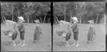 Edgar Williams empties a box of hay over his brother Owen Williams while Edith Kenworth looks on, at Motohou, Brunswick, near Wanganui
