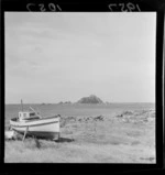 Fishing boat on the shore at Island Bay, Wellington, including Tapu Te Ranga Motu Island