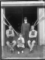 Men's coxed double rowing team, unidentified men and young boy coxswain and coach in suit and bowler hat, outside the Avon Rowing Club boatshed, Christchurch