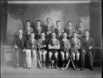 Studio portrait of an unidentified men's hockey team with their cup, probably Christchurch region