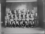 Unidentified group of schoolboy hockey team members and coaches, showing a cup and hockey sticks, taken in the studio, probably Christchurch district