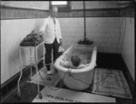 Administering therapeutic treatment to a patient in a slipper bath, Government Sanatorium and Baths, Rotorua