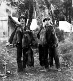 Two unidentified men with a substantial oppossum catch