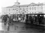 Three tram carriages, full with passengers, Cathedral Square, Christchurch