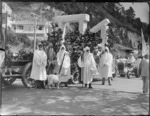 New Napier Week Carnival, trailer float with Stonehenge megalithic type arches, men dressed as Druids standing in front with goat, Napier, Hawke's Bay District