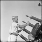 Seaman with a small anti aircraft gun on HMS Leander