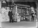 Street view of Simpson & Williams Ltd newsagents selling books, magazines and The Star, Lyttelton and Canterbury Times newspapers, with two unidentified men and a newsboy, Christchurch region