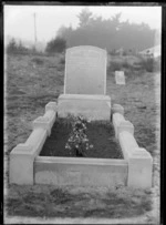 Headstone and grave plot with flowers of Robert Hartley who died 8 May 1924 aged 42, husband of Annie Uren, grass and trees beyond, Bromley Cemetery, Christchurch