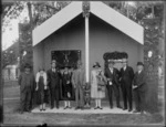 Maori meeting house, Ebbett House, Ebbett Park, Hastings with men and women standing in the front