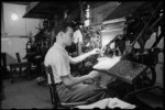 M Simon Hosney, linotype operator, working on corrections to the NZEF Times in Cairo, Egypt, World War II - Photograph taken by George Bull