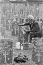 Roy Towers cleaning a war veteran's headstone, Karori Cemetery, Wellington - Photograph taken by Mark Round