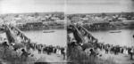 Crowd watching a boat race on the Waitara River