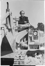 Father Gerard Mills, Rector of St Patrick's College, Wellington, driving a truck loader at the school's new site in Rongotai, Wellington