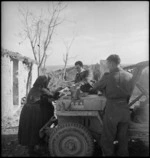 New Zealand soldiers giving bread to an Italian woman in the Sangro River area, World War II - Photograph taken by George Kaye