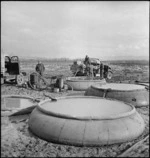 Canvas water tanks and water cart of NZ Division on banks of the Sangro River in Italy, World War II - Photograph taken by George Kaye