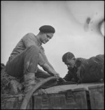 F J Humphries and K D Leydon examining depth of water in water storage cart in Italy, World War II - Photograph taken by George Kaye