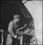 R Baker, of NZ Divisional Workshops, carries out repairs behind the lines on the Italian Front, World War II - Photograph taken by George Kaye