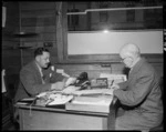 Hata Ruru, Wanganui land agent, interviewing a client in his office - Photograph taken by T Ransfield