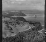 The Snow Rainger property on a headland with buildings, bush and steep cliffs north of Hatfield's Beach settlement, North Auckland, with the Hibiscus Coastal Highway and the Waiwera Hill Scenic Reserve