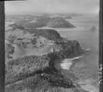 The Snow Rainger property on a headland with buildings, bush and steep cliffs north of Hatfield's Beach settlement, North Auckland, with the Hibiscus Coastal Highway and the Waiwera Hill Scenic Reserve