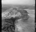 The Snow Rainger property on a headland with buildings, bush and steep cliffs north of Hatfield's Beach settlement, North Auckland, with the Hibiscus Coastal Highway and the Waiwera Hill Scenic Reserve