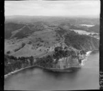 The Snow Rainger property on a headland with buildings, bush and steep cliffs north of Hatfield's Beach settlement, North Auckland, with the Hibiscus Coastal Highway and the Waiwera Hill Scenic Reserve