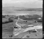 Portland Cement Works and residential village with jetty and railway on the inner Whangarei Harbour, with limestone quarry in the foreground, Northland