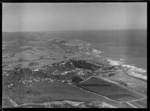 Muriwai Beach coastal settlement and pine plantation, farmland beyond, Auckland Region