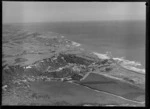 Muriwai Beach coastal settlement and pine plantation, farmland beyond, Auckland Region