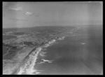 Muriwai Beach with pine plantation and coastal settlement, looking south to farmland beyond, Auckland Region