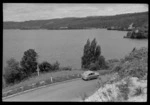 Lake Rotoiti, Rotorua District, includes a sign reading 'Lake Rotoiti' and a car parked on the side of the road