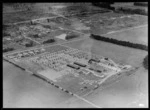 Egmont Box Company factory with saw mill and stacked lumber, with the township of Tokoroa beyond, Waikato Region