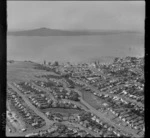 Mission Bay with Aotea Street and the M J Savage Memorial Park, Tamaki Drive on beach front, with Rangitoto Island beyond, Auckland City