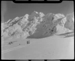Mount Cook Air Services Auster ZK-BLZ Ski Plane and two unidentified people at the head of the Tasman Glacier with Mount Tasman beyond, Mount Cook National Park, Canterbury Region