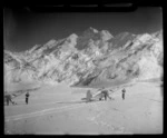 Two Mount Cook Air Services Auster ZK-BLZ Ski Planes and four unidentified women at the head of the Tasman Glacier with Mount Tasman beyond, Mount Cook National Park, Canterbury Region