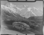 Mount Cook and Southern Lakes Tourist Coach at the Hermitage Mount Cook Village with Mount Sefton beyond, Mount Cook National Park, Canterbury Region