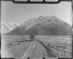 Mount Cook and Southern Lakes Tourist Coach on the Hermitage Road, Mount Cook Village, with Mount Wakefield beyond, Mount Cook National Park, Canterbury Region