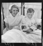 Lost child, Keith Neal, recovered, with nurse E Kean