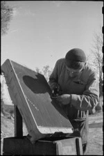 M Carkeek repairs radiator core at 2 NZ Divisional Field Workshops, Italian Front, World War II - Photograph taken by George Kaye