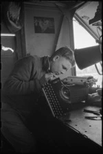J E Thompson adjusts a typewriter at NZ Divisional Field Workshops, Italian Front, World War II - Photograph taken by George Kaye
