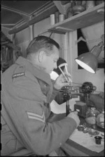 O W Wright repairing army watches at NZ Divisional Field Workshops, Italian Front, World War II - Photograph taken by George Kaye